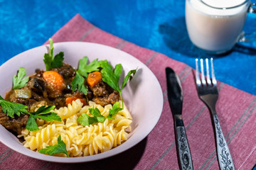 beef stew with vegetables and pasta spiral with greens