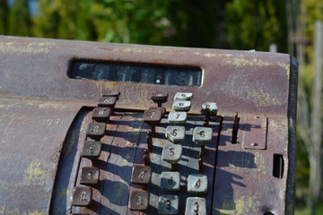 Old rusty abandoned cash register in the open air
