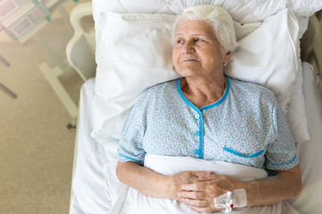 Senior female patient in hospital bed