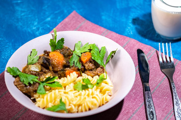 beef stew with vegetables and pasta spiral with greens