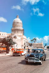 Classic  cars in downtown Havana next to the Capitol building