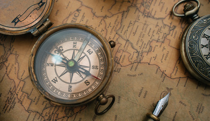 Fototapeta na wymiar Antique Compass On Old World Map