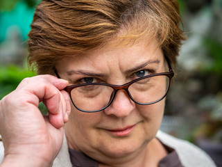 Middle-aged woman with glasses resting