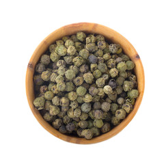 heap of peppercorn in wooden cup isolated on white background. top view