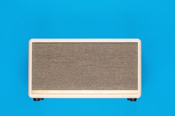 A marshall speaker on blue background, shot from above.