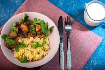beef stew with vegetables and pasta spiral with greens