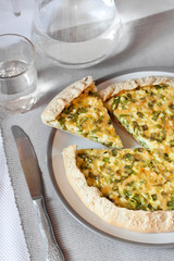 Tart with eggs and green onions on a plate