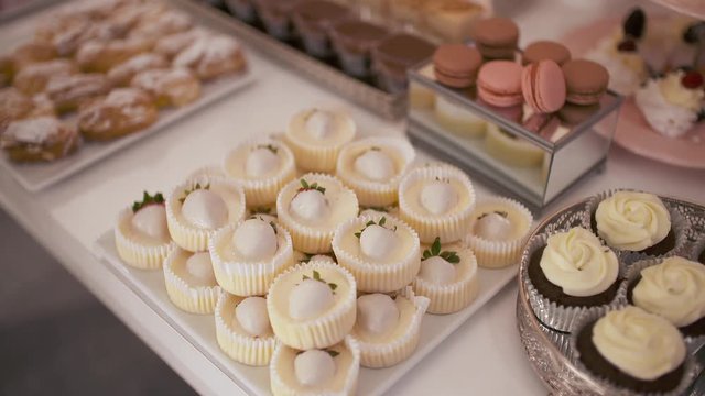Cute candy bar with various cakes and candies. Wedding candybar.