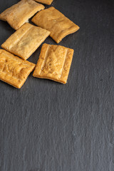 Top view of toasted muffins on slate background in vertical with copy space