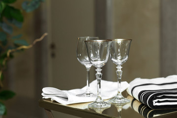 Empty glasses and glasses with a gold border stand on the wedding ceremony. Jewish and Jewish traditions