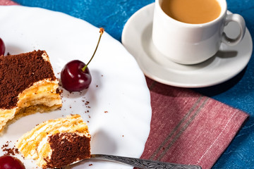 delicate, light tiramisu cake and a Cup of hot coffee with milk