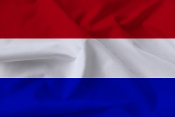 beautiful national flag of holland on soft silk with soft folds close up