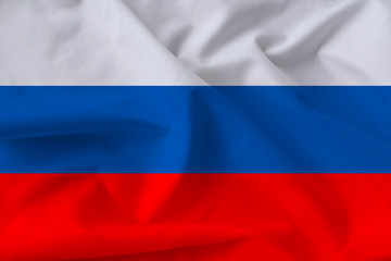 beautiful national flag of Russia on soft silk with soft folds close-up