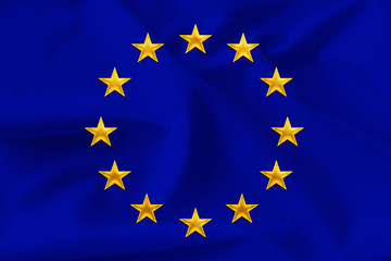 beautiful national flag of the European Union on soft silk with soft folds close-up on the background, the concept of unity, cooperation, international union