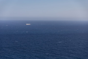 Fototapeta na wymiar Big cruiser boat far on the horizon