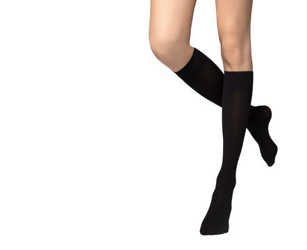 Female legs in black socks on white background
