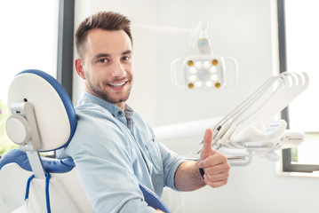 Man showing thumbs up at the dental clinic