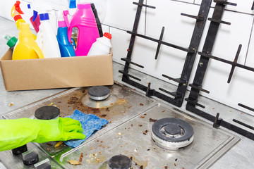 Cleaning a gas stove with kitchen utensils, household concepts, or hygiene and cleaning.