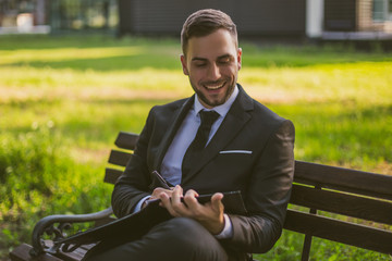 Fototapeta premium Elegant businessman working outdoor.Toned photo.