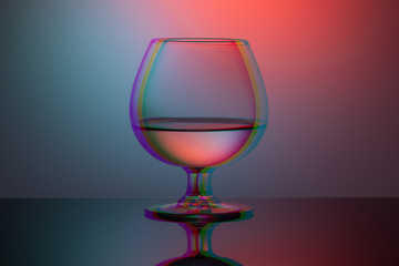 one cognac glass on the table duotone and glitch effect