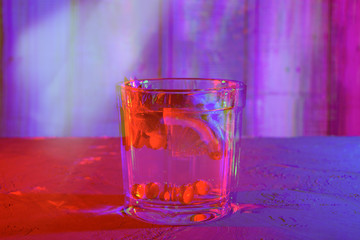 cocktail with sea buckthorn, mint and lemon on the table, anaglyph and glitch effect, neon light