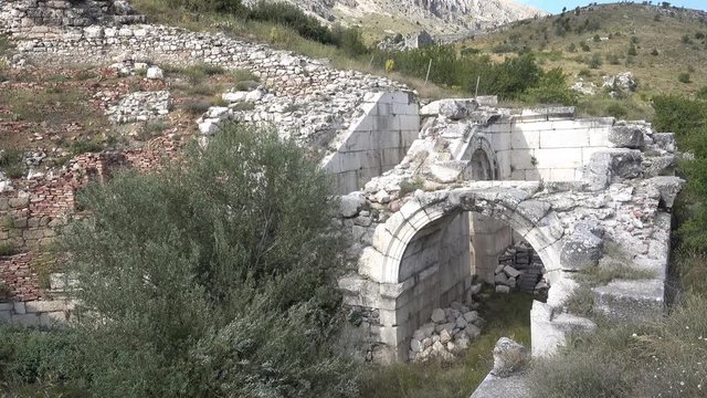 Antalya region, Turkey - 8th of July 2018: 4K Sagalassos ancient city tour - Arches at the entrance to the odeon