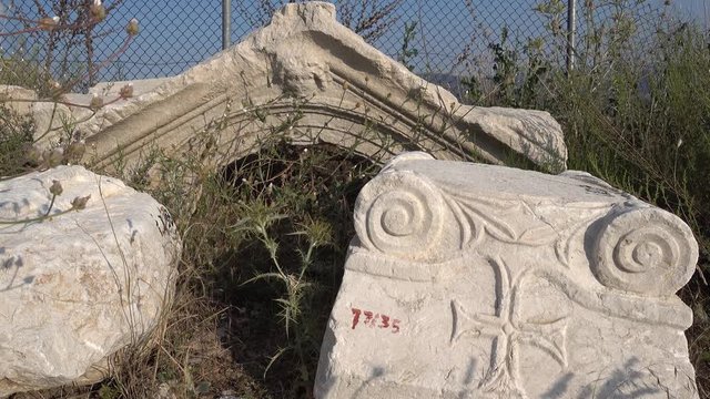Antalya region, Turkey - 8th of July 2018: 4K Sagalassos ancient city tour - Ruin fragments with unique engravings in the grass