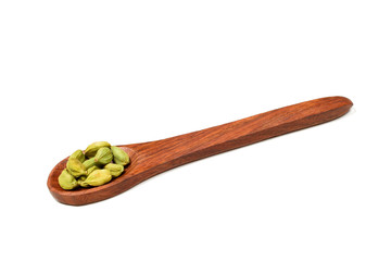 cardamom in wooden spoon isolated on white background.