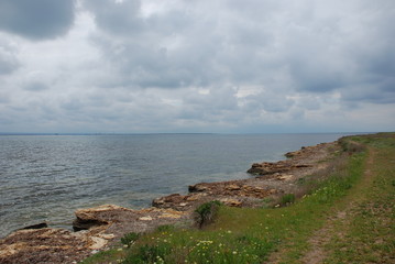 Fototapeta na wymiar Coast, road along the sea, sea, horizon and clouds.