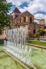 Cathedral Notre Dame in Dax town, as seen from the park, the fountain is at foreground. Southwestern France, Landes, Nouvelle Aquitaine. - obrazy, fototapety, plakaty
