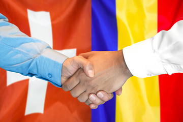 Business handshake on the background of two flags. Men handshake on the background of the Switzerland and Moldova flag. Support concept