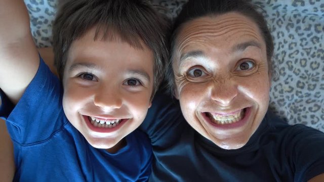 4K Selfie Mother and son clown making funny faces, crystal child