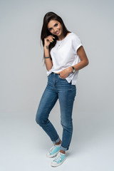 Full length portrait of a smiling pretty woman isolated over white background.