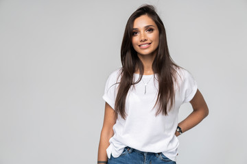 Pretty smiling joyfully female with fair hair, dressed casually, looking with satisfaction at camera, being happy. Studio shot of good-looking beautiful woman isolated against blank studio wall.