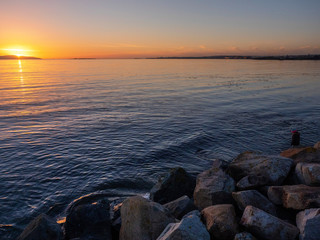 Sunset over Galway Bay, Salthill silhouette on the right, Warm and cool tones. Ireland.