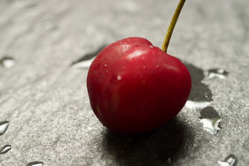 Fresh red cherry on black background 