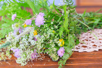 A bouquet of summer wild herbs and flowers in nature, the summer solstice. Summer sun celebration