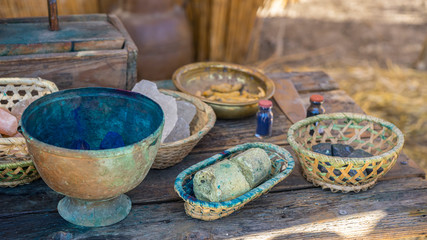 Naklejka premium Utensils, handmade dyeing of fabrics and wool in a cauldron with colored dyes in a medieval fair in Spain