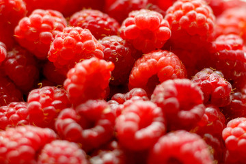Heap of sweet red raspberries close up for background