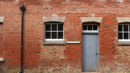 Old brick wall with door and windows