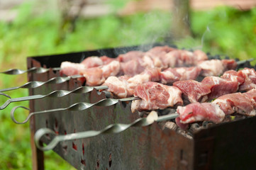 Barbecue cooking meat on skewers