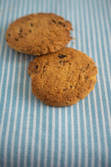 Top view of two cookies on kitchen cloth background in vertical with copy space