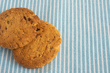 Top view of two cookies on kitchen cloth background with copy space