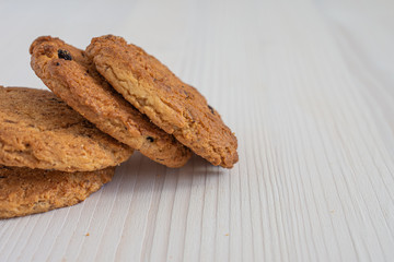 Close-up of cookies on white wooden background in horizontal with copy space