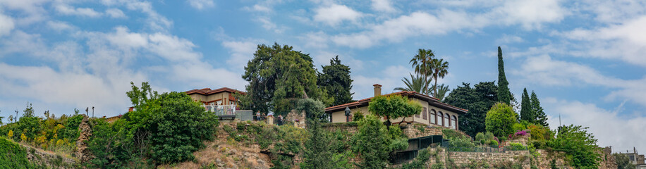 Fototapeta na wymiar Luxurious villa among the trees against the sky