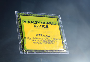 Close up of a parking penalty notice attached to a car windscreen. Known also as a PCN or Parking Charge Notice or Parking Ticket.  - obrazy, fototapety, plakaty