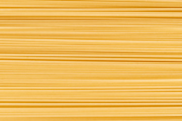 abstract backgroung with raw or uncooked spaghetti noodles texture, copy space for text