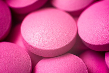 Pills in a pink color. Macro details of tablets. Close up. Cfn use as background in medicene.