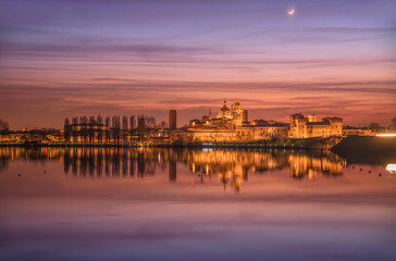UNESCO World Heritage site Mantua city illuminated after the sunset with reflections on the lake