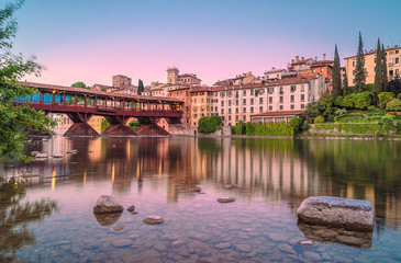 Bassano del Grappa during the sunset with city reflections on Brenta River - obrazy, fototapety, plakaty